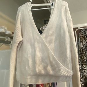 Deep V, white sweater. Open back.